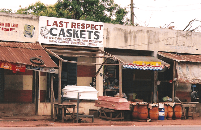 A store front with a sign that says " last respect caskets ".